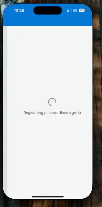 Microsoft Authenticator on iPhone showing a progress indicator while registering passwordless sign-in