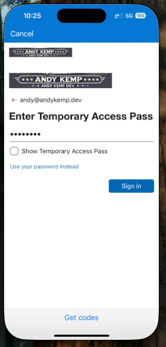 Microsoft sign-in screen on iPhone with an "Enter Temporary Access Pass" field, the value hidden, and a Sign in button