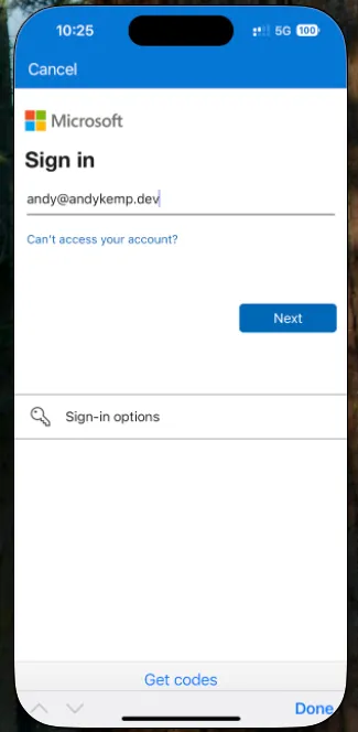 Microsoft sign-in screen on iPhone with an example username entered and a Next button
